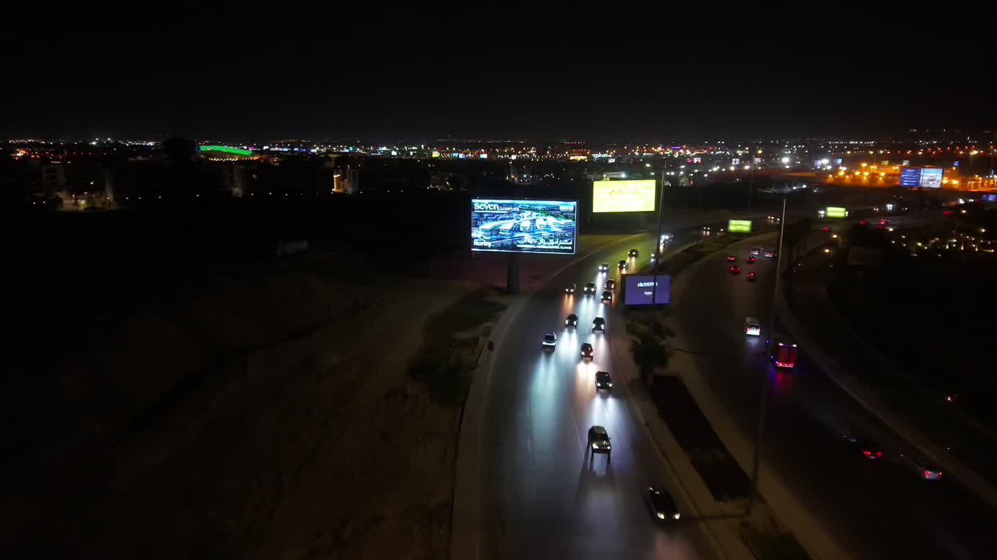 Illuminated Nexus billboard over a Cairo highway at night
